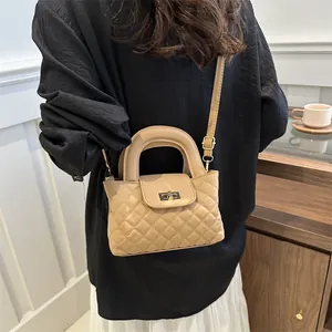 Quilted crossbody bag in beige featuring gold twist lock and elegant round handle detail