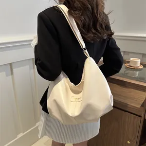 Detailed back view of a minimalist cream PU leather large capacity crossbody hobo bag