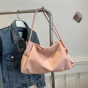 Detail of pink soft leather tote bag with knotted strap and embossed VVGNOGZHU letters