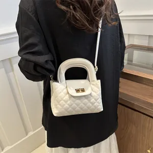 Chic white quilted crossbody bag with gold hardware and top handle for women's fashion