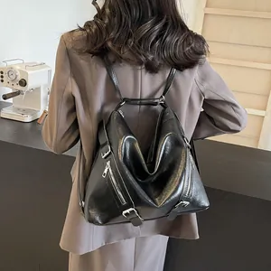 Versatile black leather tote backpack for women shown in a stylish indoor setting