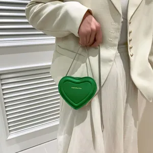 Mini sac à bandoulière vert en forme de cœur avec texture cuir et chaîne argentée