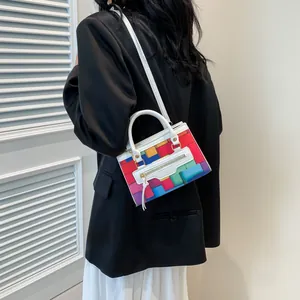 Model showing a colorful geometric patchwork crossbody bag with a white shoulder strap