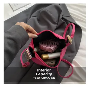 Macro view showing the internal capacity of the pink embossed leather square crossbody bag