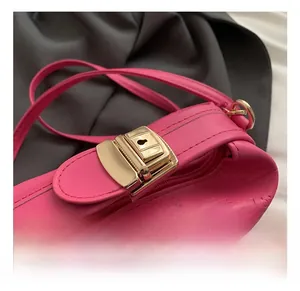 Close-up of golden metal lock and rich rabbit embossing on rose pink leather bag