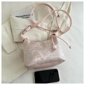 Detail of pink jacquard shoulder bag with traditional Chinese architecture pattern