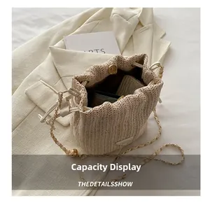 Detail showing the large capacity and brown interior of the beige woven straw bucket bag