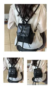 Detail showing cross-laced black leather bow and gold metal rings on a mini backpack