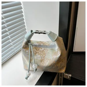 Detail of Chinese style jacquard mini handbag with mountain pattern and metal buckle