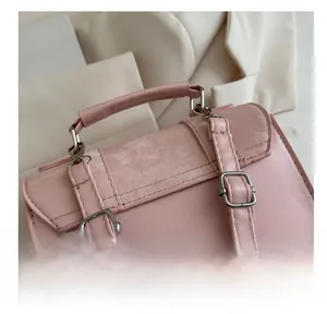 Detailed close-up of pink leather shoulder strap with adjustable silver metal buckle