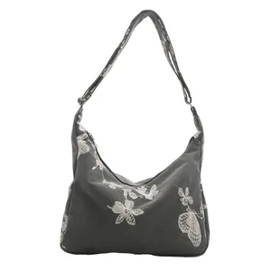 Deep grey canvas shoulder bag with white butterfly embroidery and adjustable strap