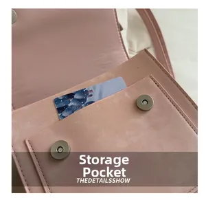 Detail of pink bag with magnetic buckles and a storage pocket with a card