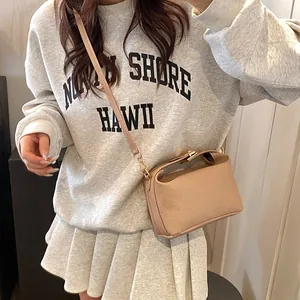 Beige faux leather crossbody bag with rich rabbit embossing and gold hardware details