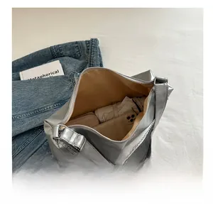 Detailed interior of a silver tote bag showing space for phone, wallet and umbrella
