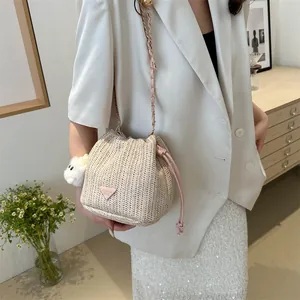 Detailed shot of woven bucket bag with pink drawstring and cute rabbit keychain accessory