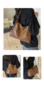 Detalle de bolso tote de cuero marrón con nudos decorativos y correas largas de hombro