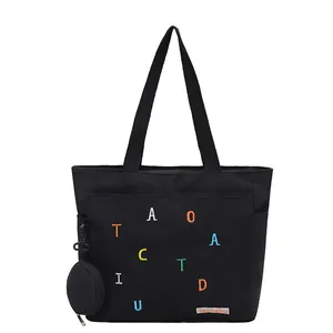 Minimalist black canvas tote bag with colorful letter embroidery and mini pouch