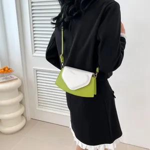 Lime green heart shoulder bag shown from back view on model for fashion look