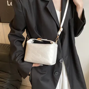 White faux leather crossbody bag with rich rabbit embossing and golden metal hardware