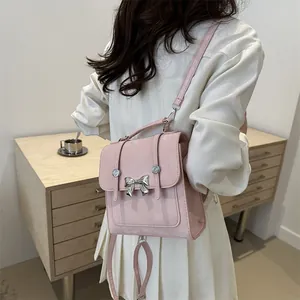 Pink faux leather butterfly bow backpack for women shown from a stylish side view angle