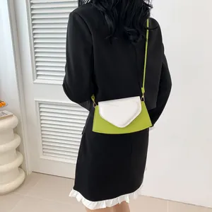 Fashionable green crossbody bag with white heart-shaped flap and elegant pearl chain strap