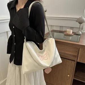 Chic white hobo bag with pink butterfly embroidery and a stylish silver chain strap