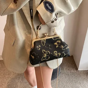 Elegant black evening bag with gold butterfly embroidery and chic metal handle