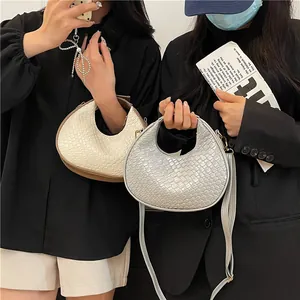 Chic crescent hobo bag with snakeskin texture in beige and metallic silver tones