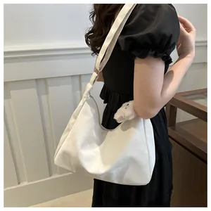 Detail of white moon tote bag with wide strap and minimalist stitching on soft PU leather