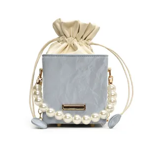 Light blue marble texture bucket bag with pearl handle and drawstring interior pocket