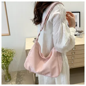 Close-up of a soft pink large-capacity tote bag with textured faux leather finish