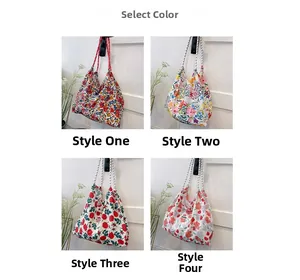 Four floral canvas tote bags with various flower patterns and rope handles hanging
