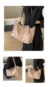 Détail de la boucle métallique ajustable sur le grand sac cabas beige en cuir souple