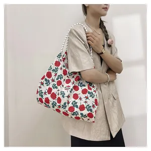 Detail of floral canvas tote bag with polka dot rope handle and Sunshine label