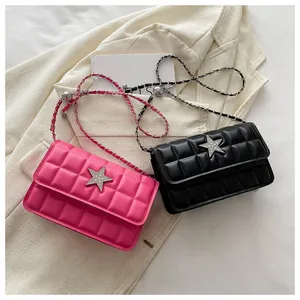 Detail view of quilted leather square bags with rhinestone star buckle and chain straps