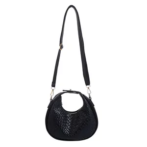 Chic black crescent handbag with woven texture and gold hardware for 2024 fashion