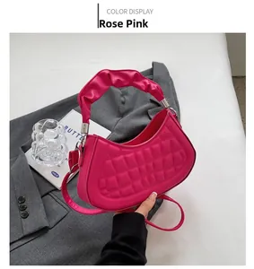 Close-up of rose pink quilted crossbody bag featuring elegant pleated ruffles on the handle