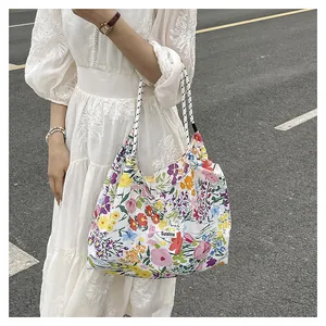 Detailed macro view of floral tote bag featuring Sunshine tag and striped handles