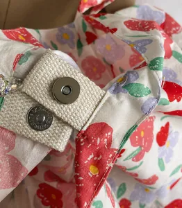Close-up of premium magnetic snap fastener on floral print canvas tote bag detail