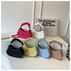 Detail of quilted leather crescent bags with cloud-style pleated handles and metal hooks
