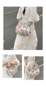 Detail of floral tote bag with Sunshine print and black-and-white braided strap