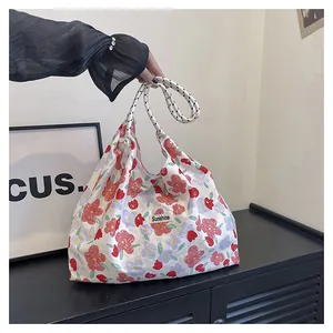 Close-up of floral print hobo bag featuring Sunshine woven label and rope handle