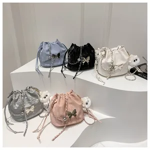 Chic bucket bags in five colors with drawstring closures and metal butterfly ornaments