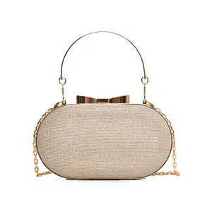 Champagne gold sequin evening clutch bag with bow clasp and metal ring handle