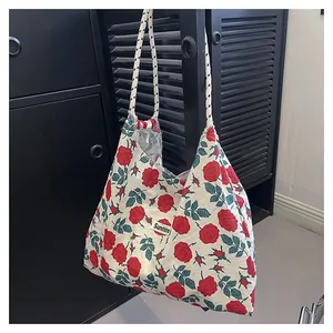 Detail of floral tote bag with red roses, Sunshine label, and woven rope handles