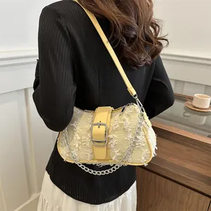 Yellow tweed shoulder bag with fringe texture, leather buckle, and metal chain strap