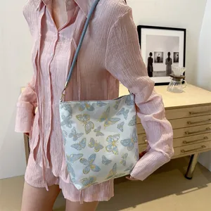 Elegant off-white shoulder bag featuring golden butterfly embroidery and slim straps