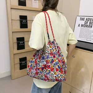 Floral fabric tote bag with Sunshine label and red braided rope shoulder straps