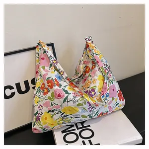 Detail of colorful floral print tote bag showing premium canvas fabric and wide handle