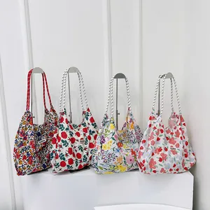 Four floral canvas tote bags with rope handles and Sunshine label in a minimalist setup